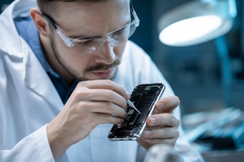 Technician Inspecting Smartphone Screen Technician Inspecting Smartphone Screen